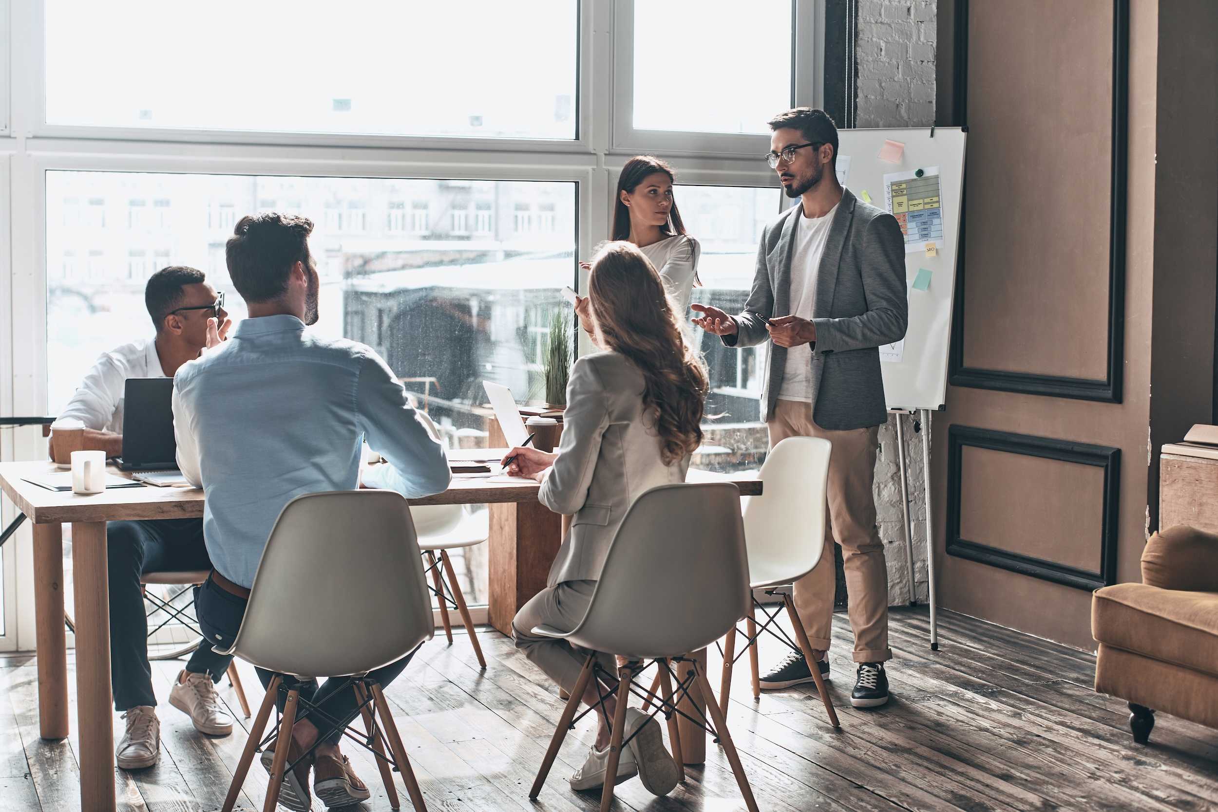 group of stylish skilled professionals having a meeting